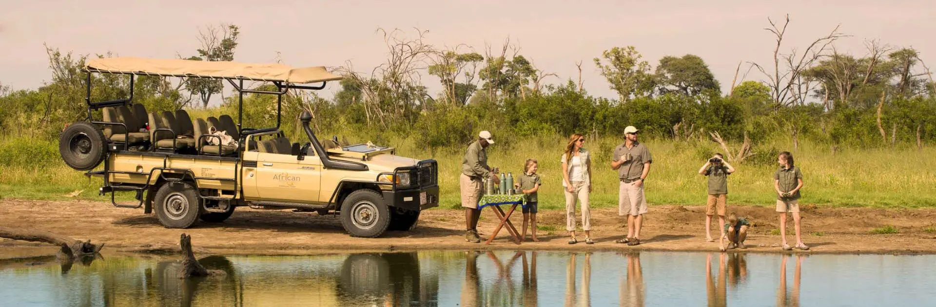 Multi-Generational Safari Guide: Planning Kenya And Tanzania For Children, Parents And Grandparents 10 Family Enjoying Bush Meal while on Safari in Zimbabwe