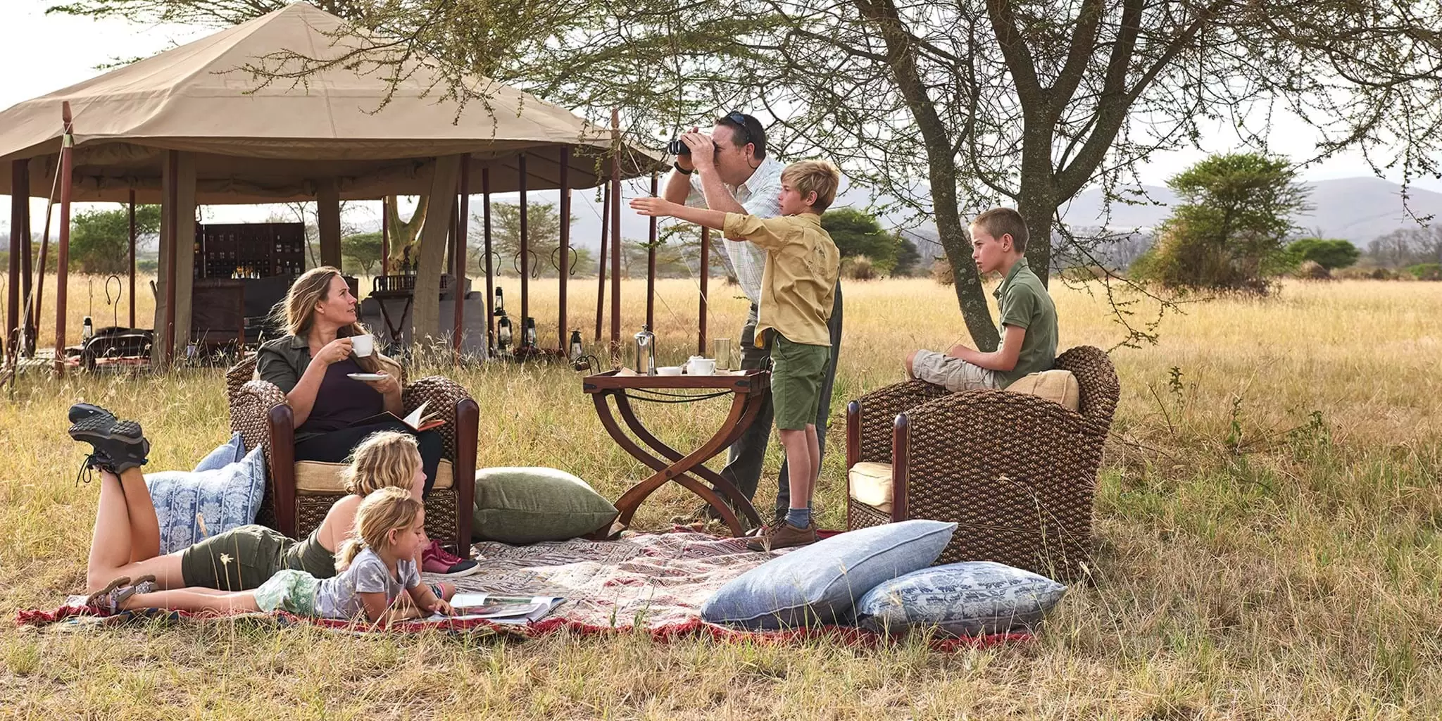 Best Family-Friendly Safari Lodges In Kenya And Tanzania: The Ultimate Family Safari Guide 4 Family Having picnic Breakfast on Safari in Serengeti Tanzania